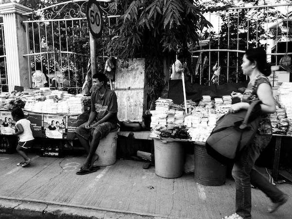 Black and white photo of people at a market.