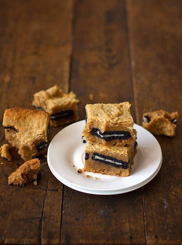 Peanut butter Oreo blondies stacked on a plate.