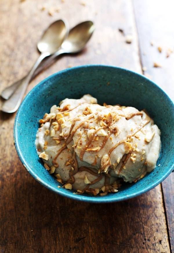 Peanut Butter Banana Ice Cream in a blue bowl with two spoons.