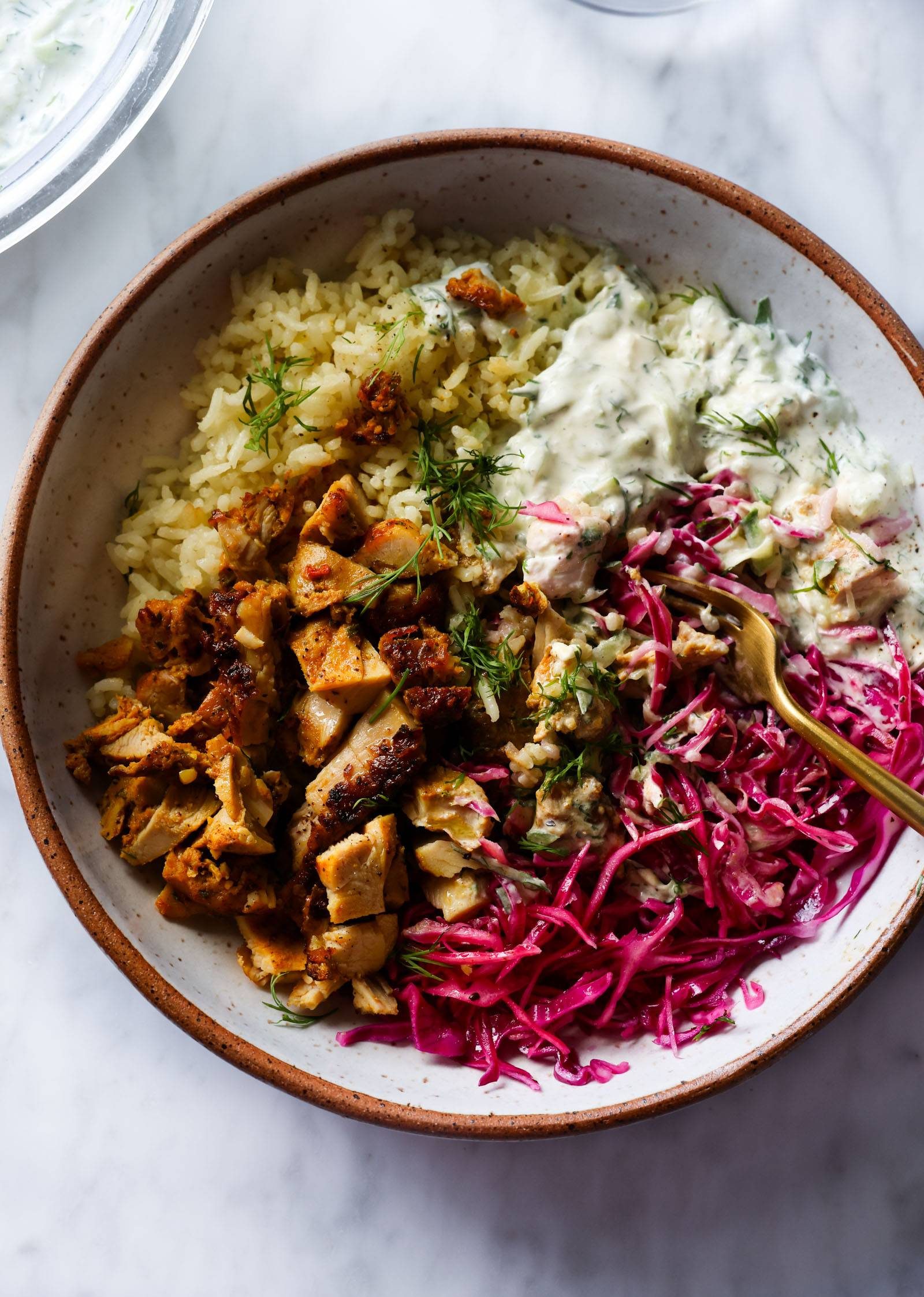 Chicken shawarma bowls with cabbage and feta sauce.