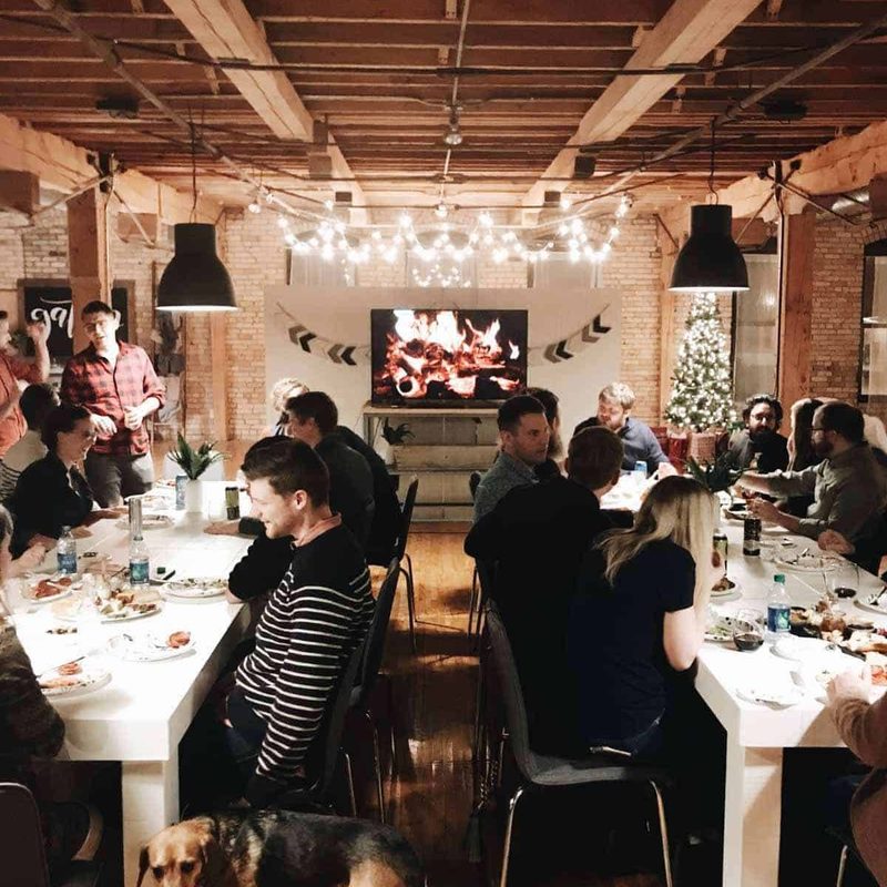 Group of friends at tables for a Christmas party.