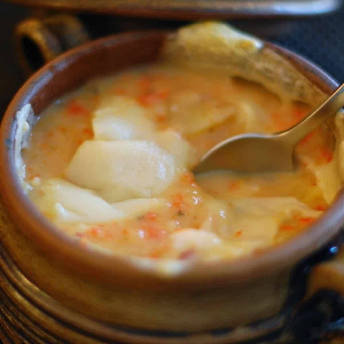 Root vegetable stew in a bowl with a spoon.