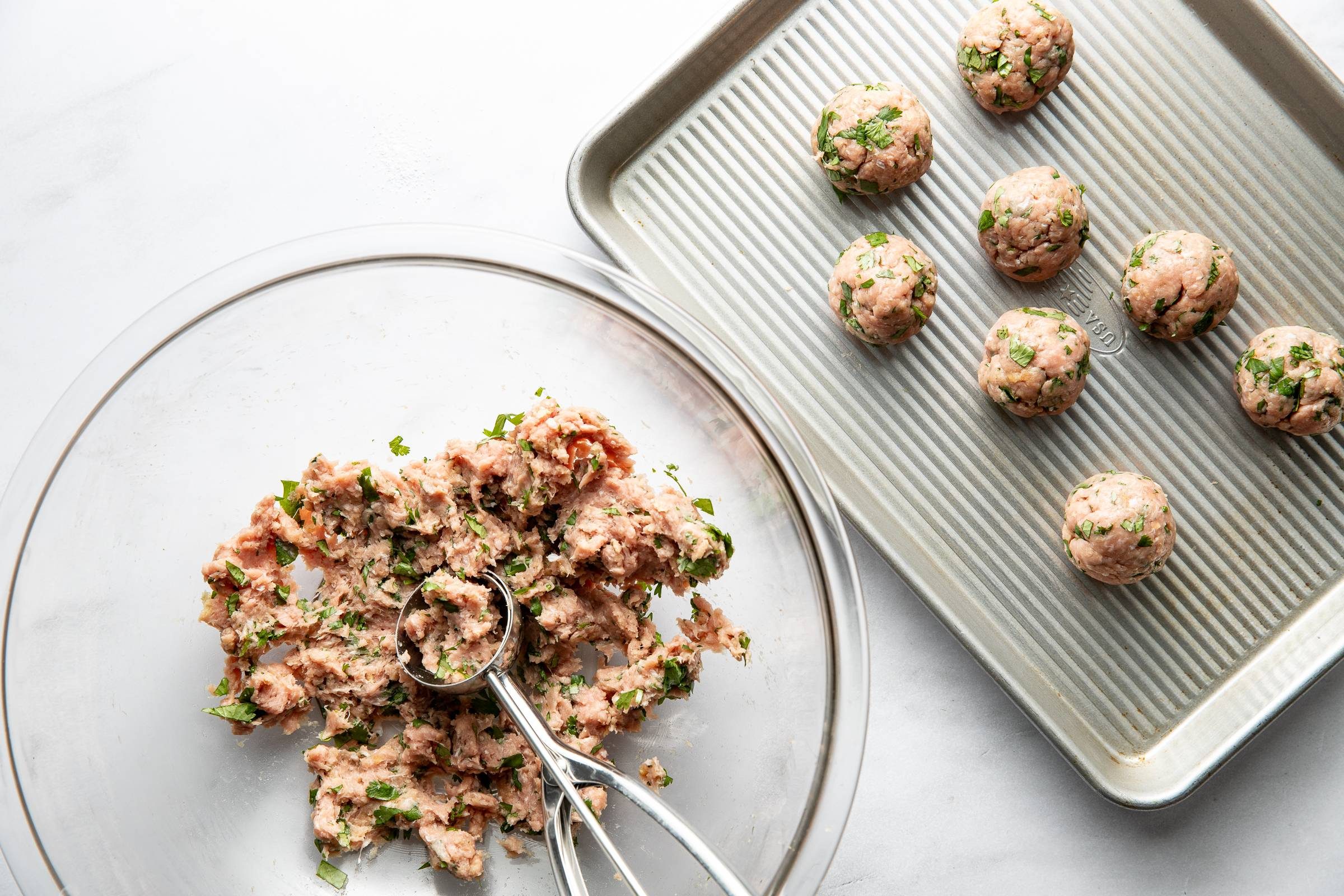 Forming meatballs into balls.